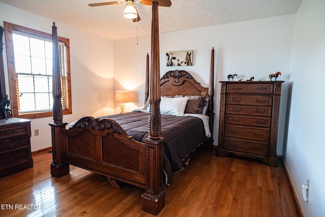 bedroom featuring a textured ceiling, wood-type flooring, and ceiling fan