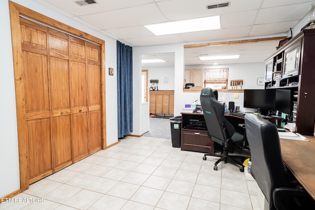 office area featuring a paneled ceiling and light tile patterned flooring