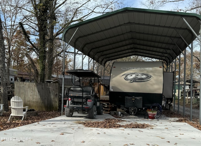 snow covered parking with a carport