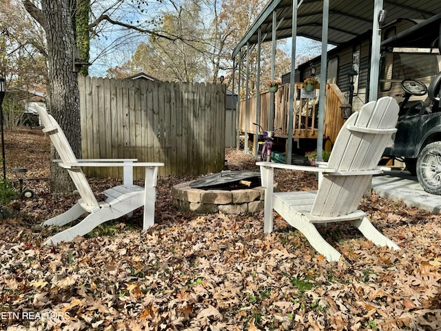 view of yard with a wooden deck and an outdoor fire pit