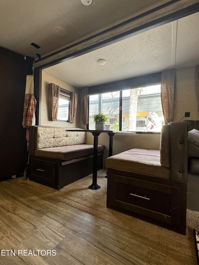 bedroom with a textured ceiling and hardwood / wood-style flooring