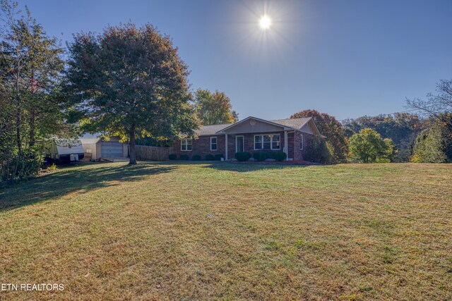 view of front of home featuring a front lawn and a garage