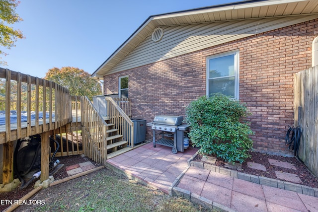 exterior space featuring a wooden deck and a patio area