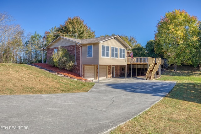 view of front of home with a garage, a wooden deck, and a front yard