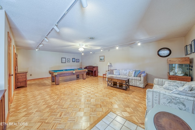 rec room with light parquet floors, a textured ceiling, billiards, rail lighting, and ceiling fan