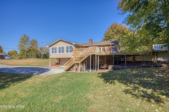 back of house featuring a deck and a yard