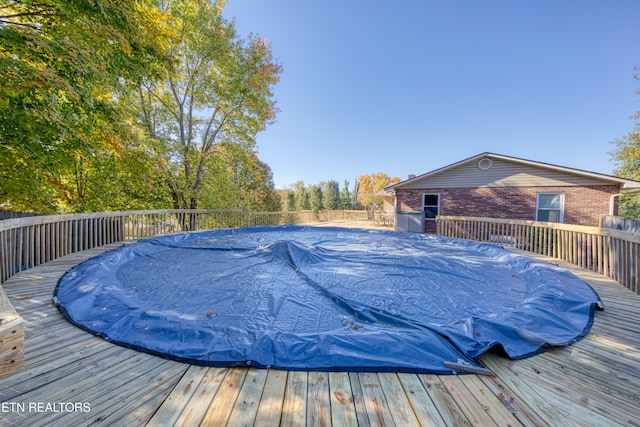 view of swimming pool featuring a deck