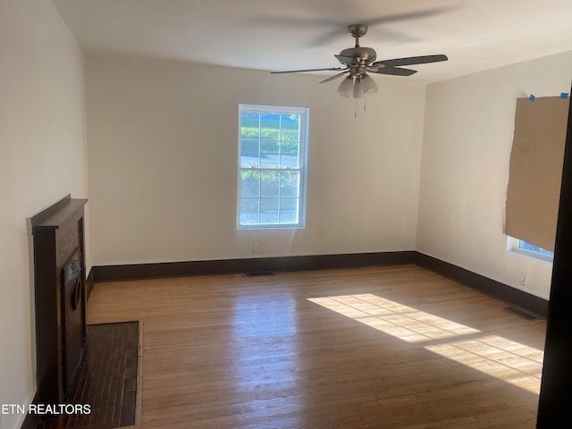 unfurnished living room featuring ceiling fan and light hardwood / wood-style flooring