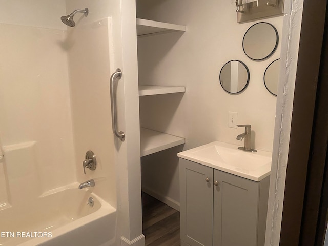 bathroom featuring shower / washtub combination, vanity, and hardwood / wood-style flooring