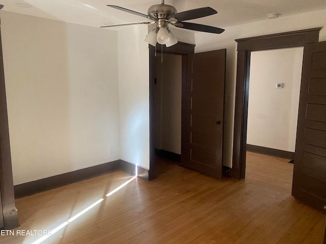 empty room with light hardwood / wood-style floors and ceiling fan