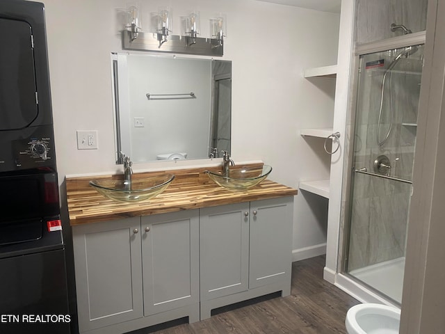 bathroom featuring hardwood / wood-style flooring, vanity, and an enclosed shower