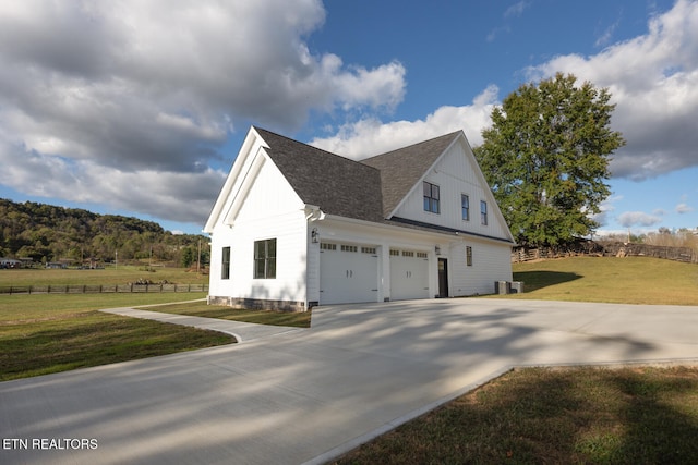 view of property exterior featuring a garage and a yard