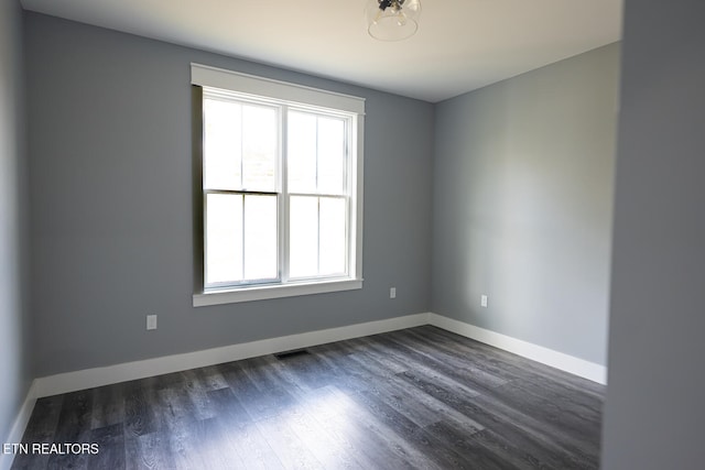 empty room with dark hardwood / wood-style floors