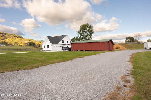 view of home's exterior featuring an outbuilding and a lawn