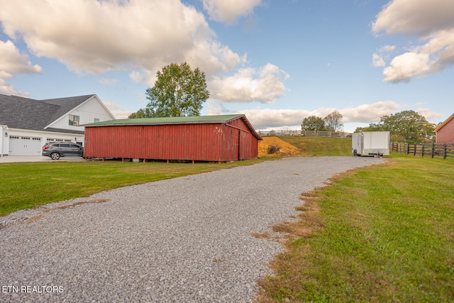 view of outdoor structure featuring a garage and a yard