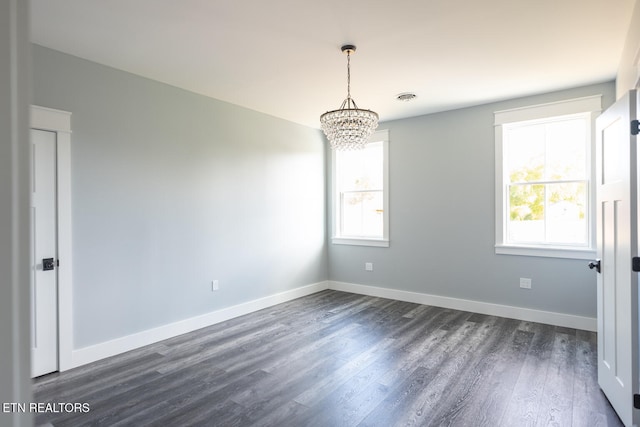 spare room featuring dark wood-type flooring