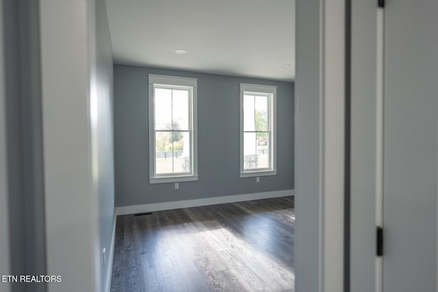 spare room with dark hardwood / wood-style flooring