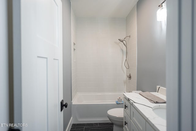 full bathroom with tile patterned flooring, vanity, tiled shower / bath combo, and toilet