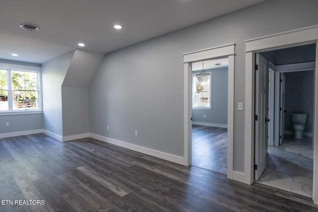 additional living space with dark hardwood / wood-style floors