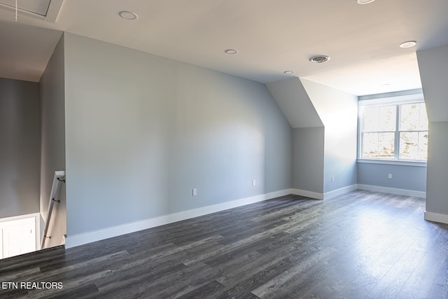 additional living space with dark hardwood / wood-style flooring