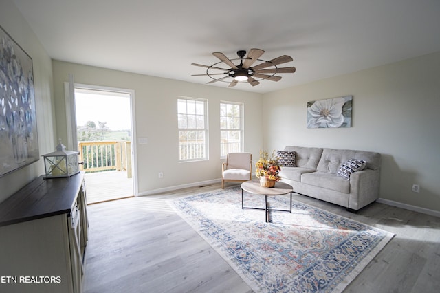 living room with hardwood / wood-style flooring and ceiling fan