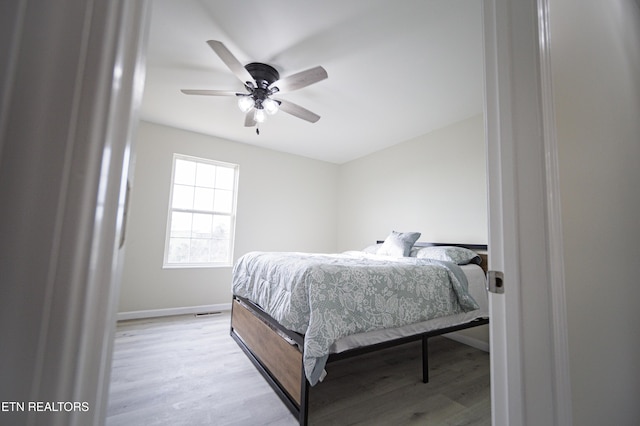 bedroom with light wood-type flooring and ceiling fan