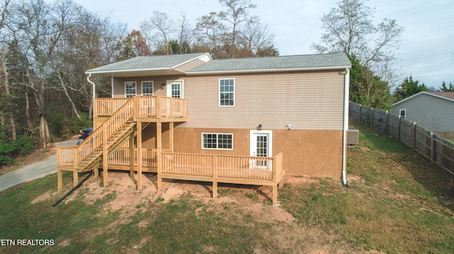 rear view of house with central AC unit and a deck