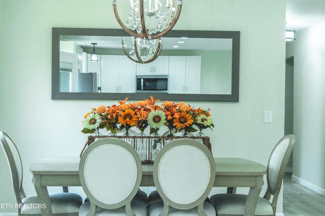 dining room with an inviting chandelier and light wood-type flooring