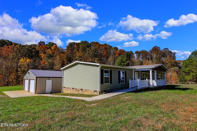 view of front facade with an outbuilding, a garage, and a front yard