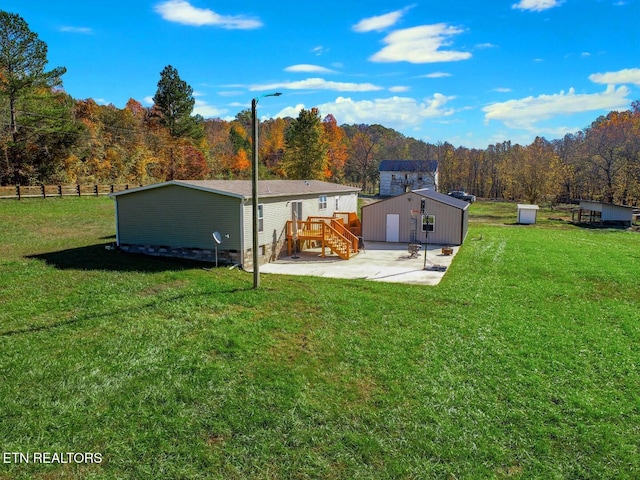 view of yard with a deck and a patio area