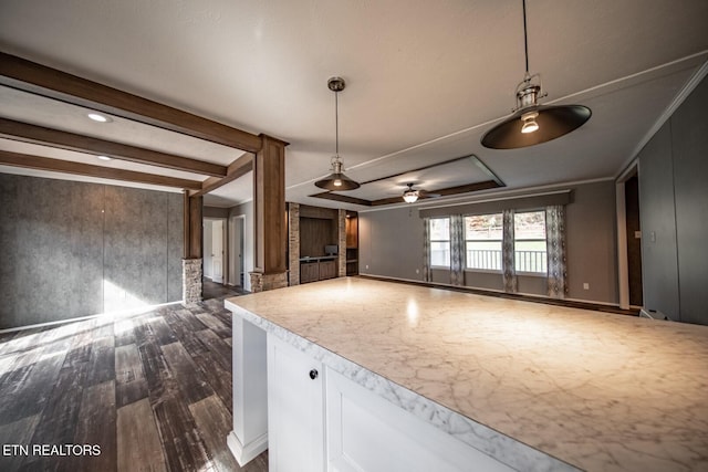 kitchen with hanging light fixtures, dark hardwood / wood-style floors, white cabinets, and crown molding