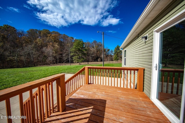 wooden deck featuring a yard