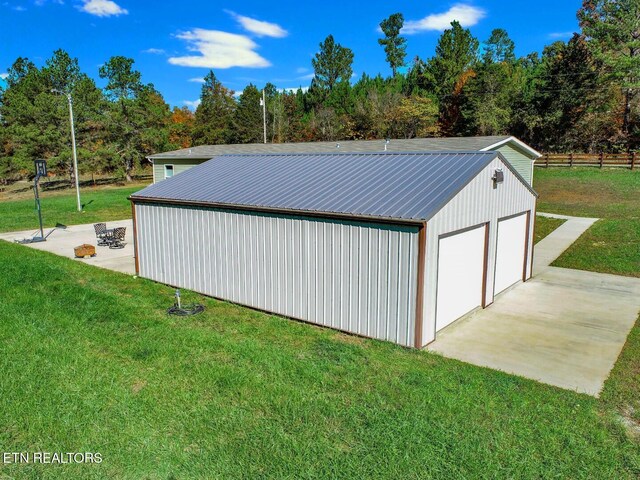 view of outbuilding with a garage and a lawn