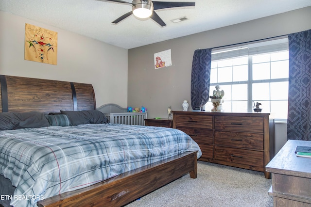 bedroom with ceiling fan and a textured ceiling