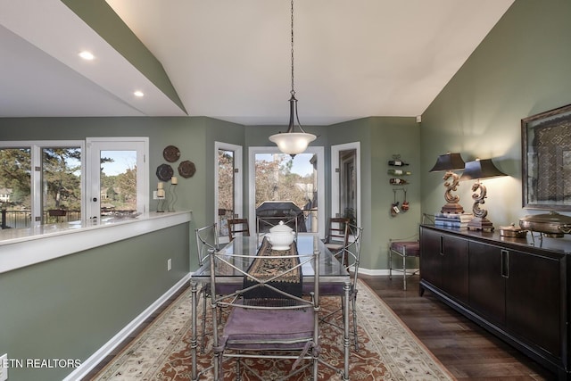 dining room featuring a wealth of natural light, dark hardwood / wood-style floors, and vaulted ceiling