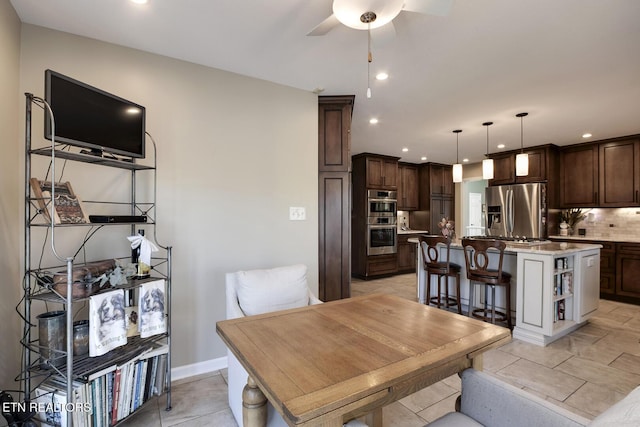 tiled dining space with ceiling fan