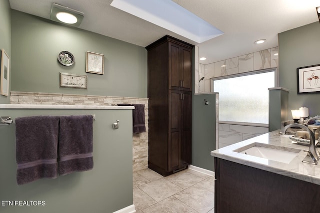 bathroom featuring walk in shower, vanity, and tile patterned floors