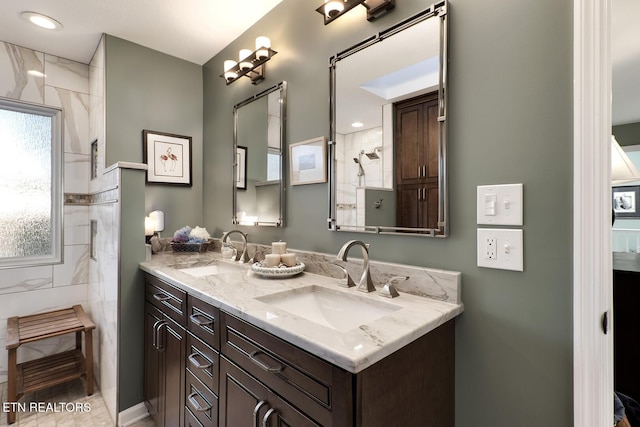 bathroom with vanity and a tile shower