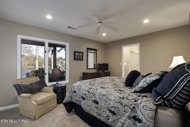 carpeted bedroom featuring ceiling fan and ensuite bath