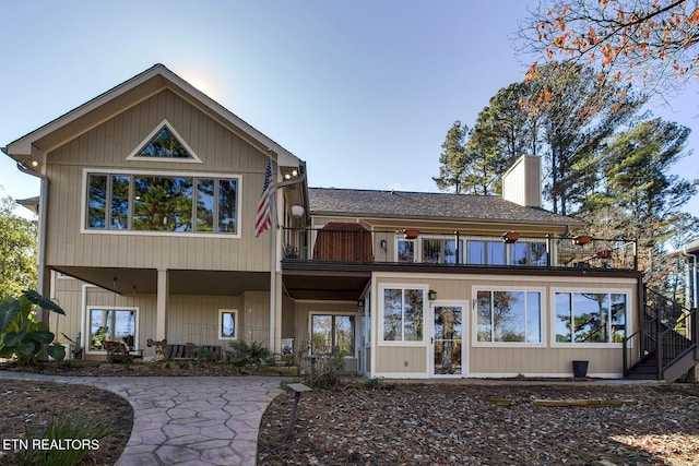 rear view of house featuring a balcony and a patio