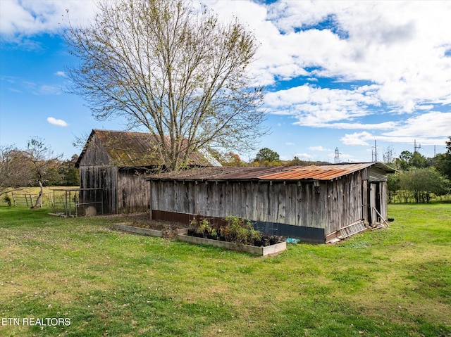 view of outbuilding featuring a yard