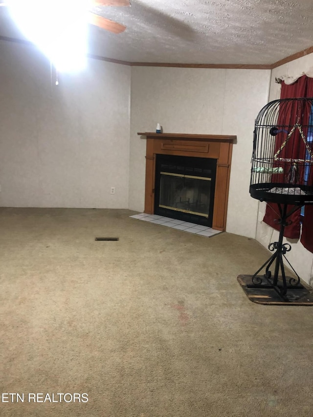 unfurnished living room with ornamental molding, carpet, and a textured ceiling