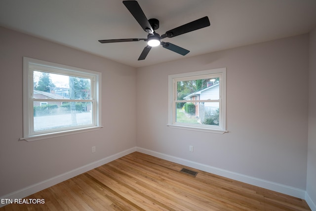 spare room featuring light wood-type flooring and ceiling fan