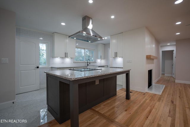 304 Firestone Rd, Oak Ridge, TN 37830 - kitchen featuring island range hood, white cabinetry, a center island, light stone counters, and recessed lighting
