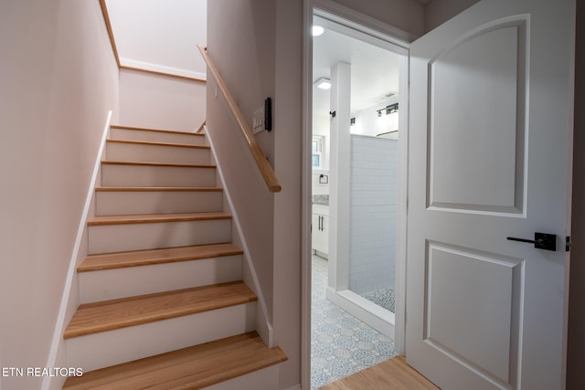 staircase featuring hardwood / wood-style flooring