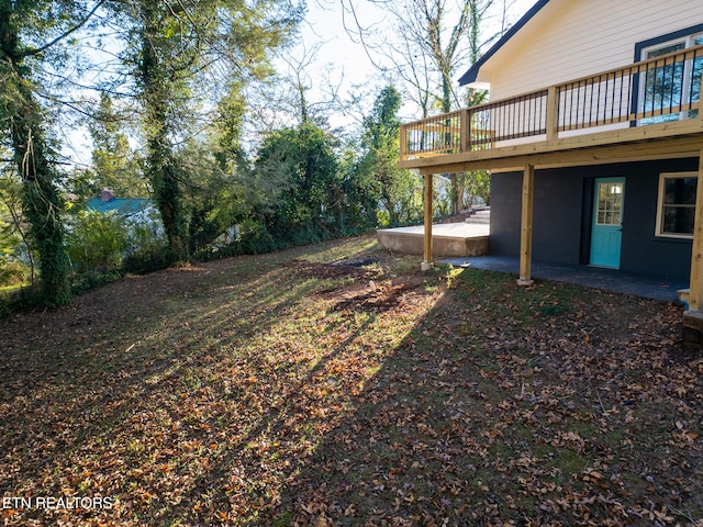 view of yard featuring a patio area and a deck