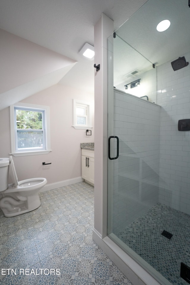 bathroom with walk in shower, vanity, and toilet