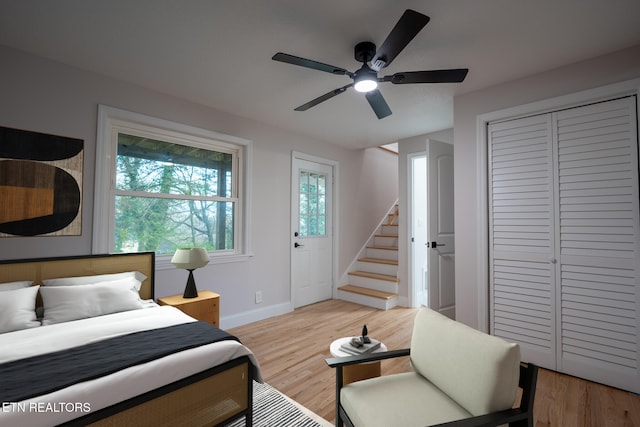 bedroom with a closet, ceiling fan, and light hardwood / wood-style flooring