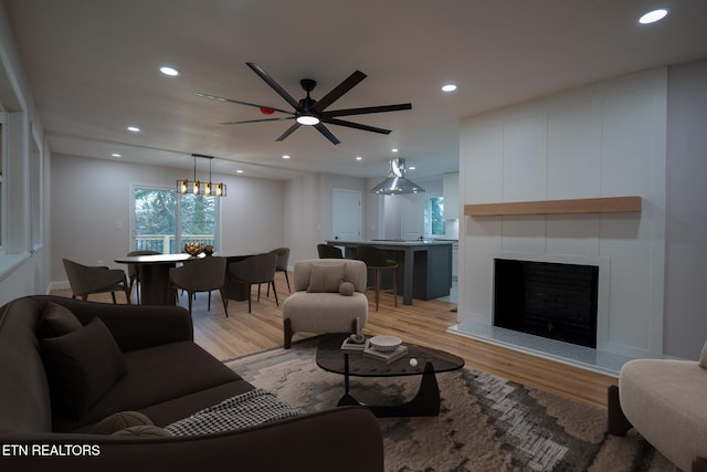 living room featuring ceiling fan and light hardwood / wood-style flooring