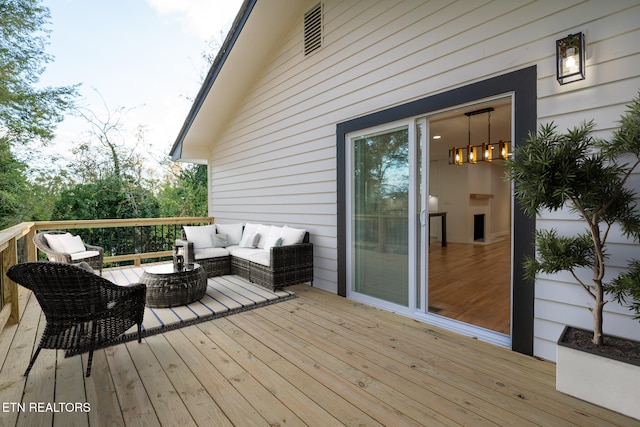 wooden terrace featuring an outdoor hangout area